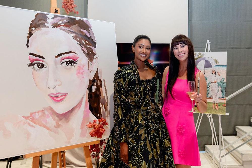 Hilde and Bryoni Govender beside the finished portrait at The Art of Collaboration 2026