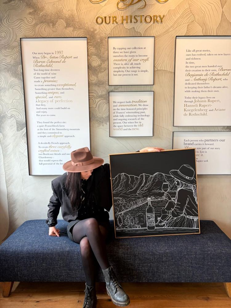 Hilde seated beside her finished line drawing at Rupert and Rothschild